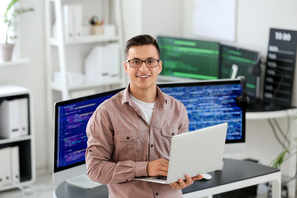 A junior developer working on a laptop.